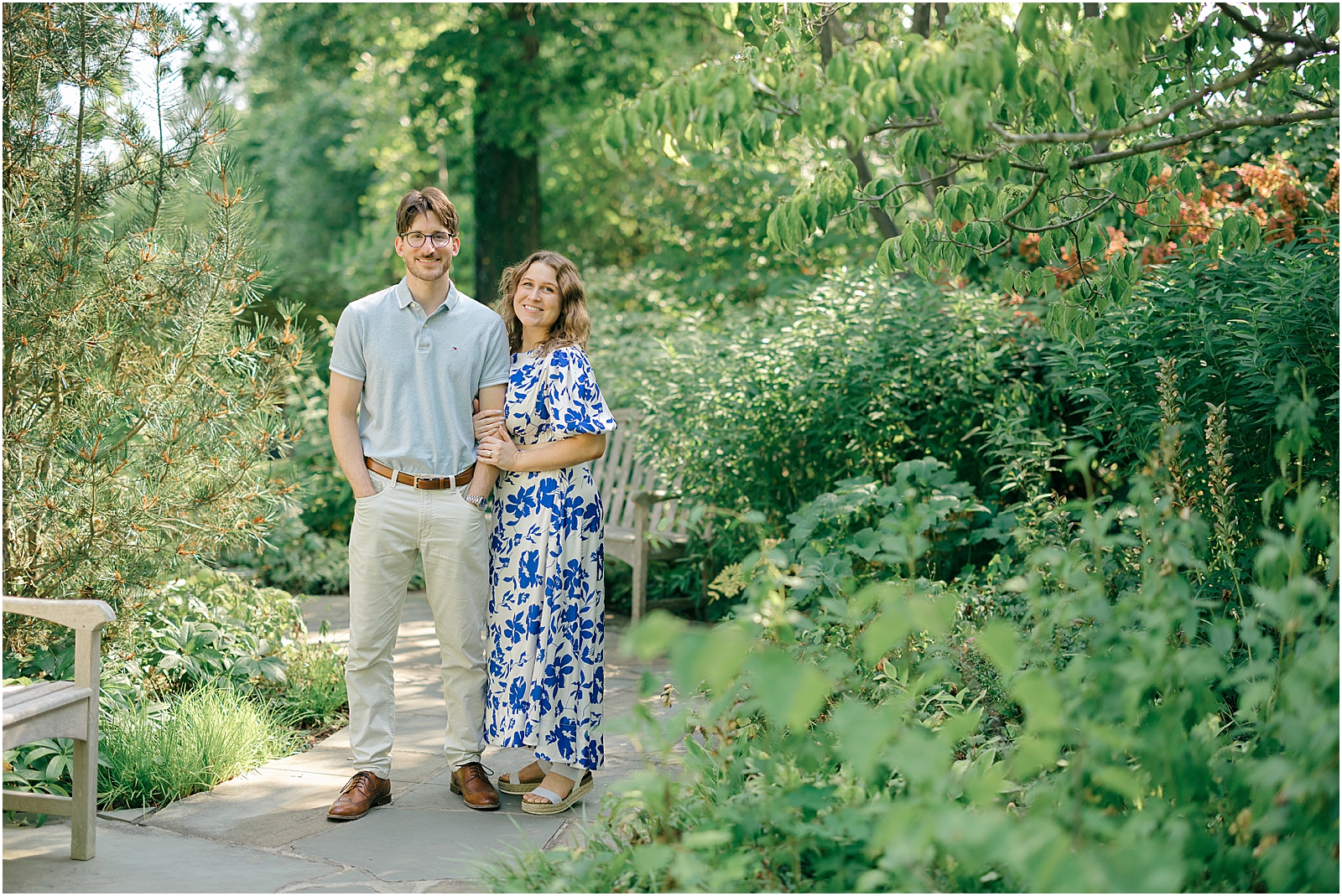 Engaged couple smiling and embracing among the greenery at Ladew Topiary Gardens near Baltimore, Maryland