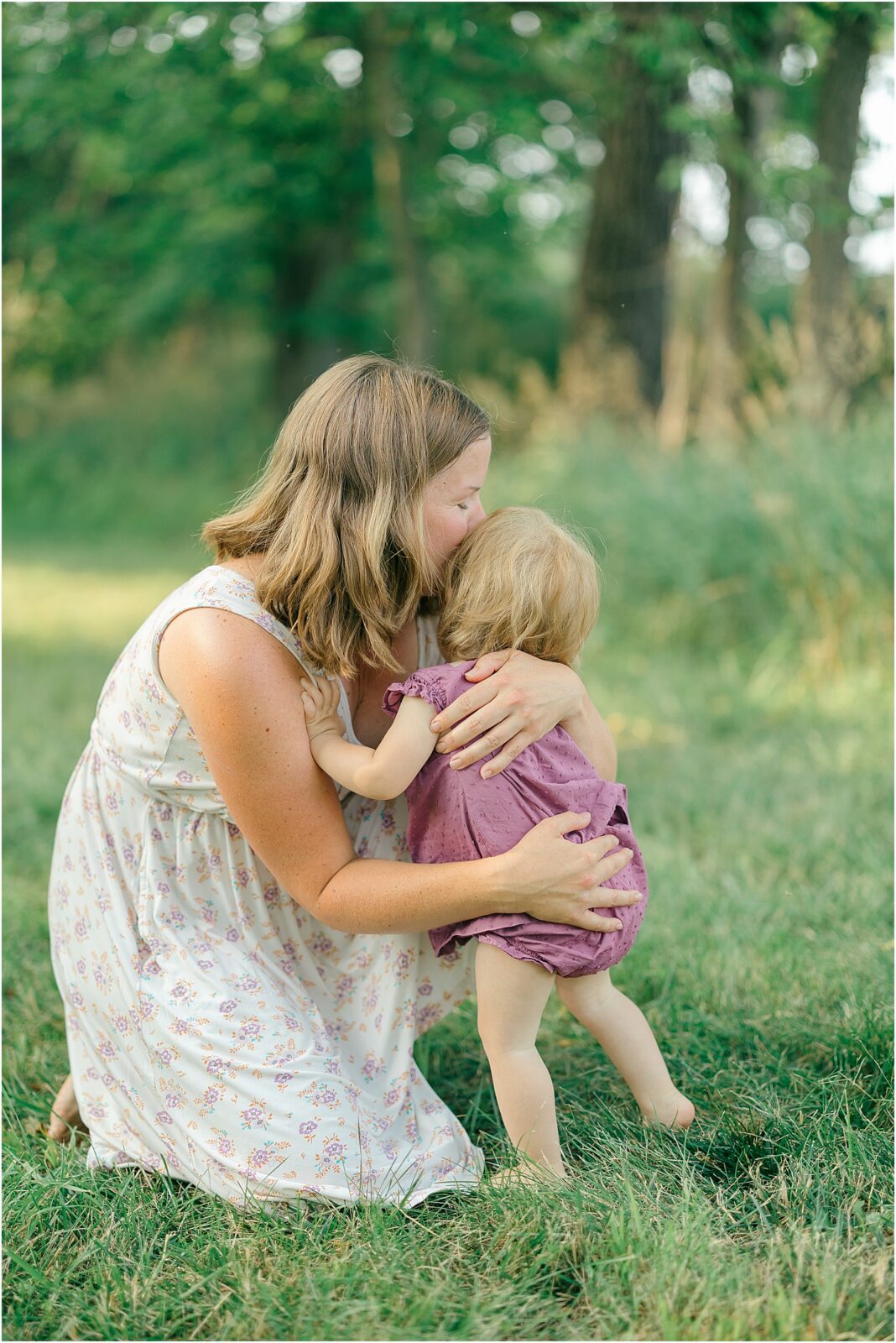 mom kisses one year old baby during first birthday photos in frederick maryland
