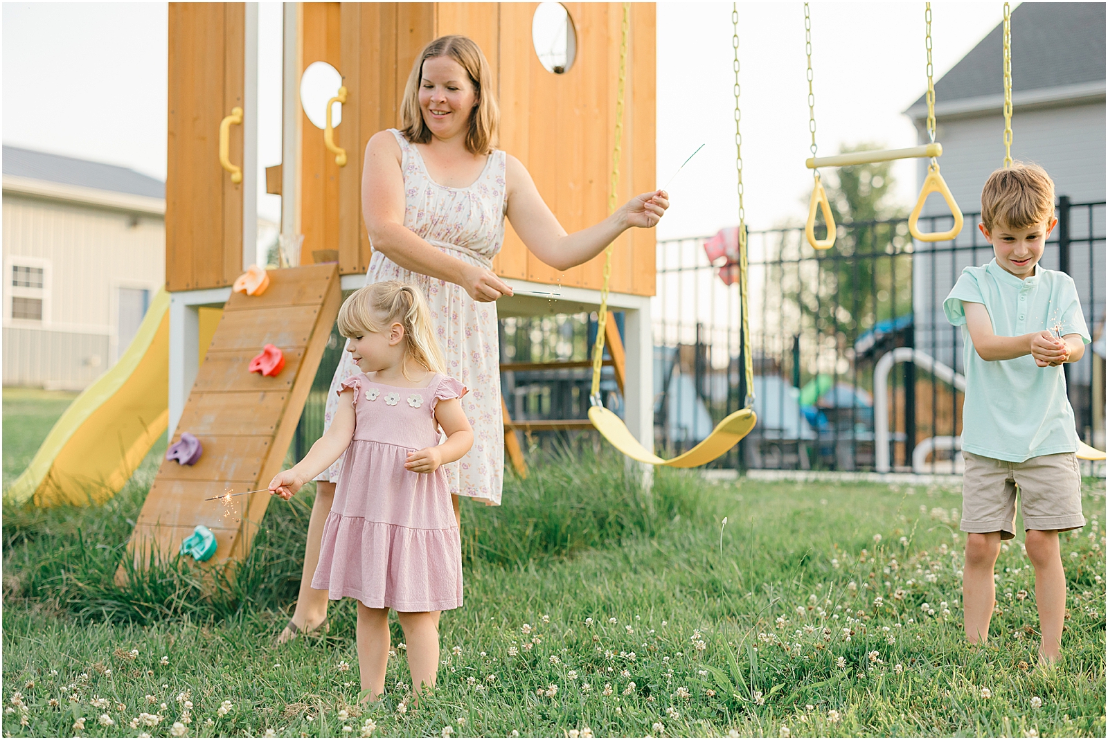 mom and kids using sparklers at their family session at their frederick maryland home